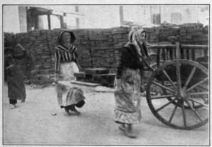 Photograph from Henry Ruschin
WOMEN CARRYING BRICKS AT BUDAPEST
A pathetic aspect of the policy "Business as Usual" inaugurated at the outbreak of
the European War. Central European women worked hard before the war, however.