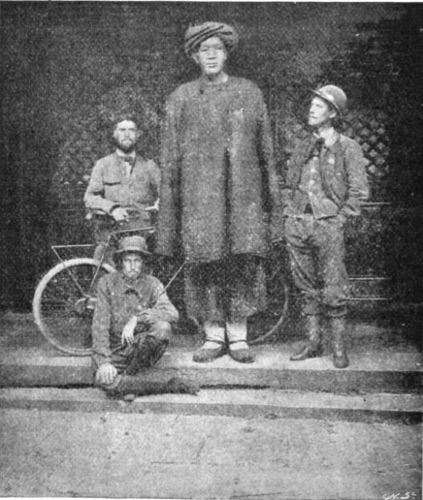 THE THREE WORLD CYCLISTS AND A CHINESE GIANT WHO DOES
NOT CYCLE.