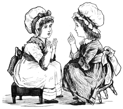 Two girls seated on low stools talking