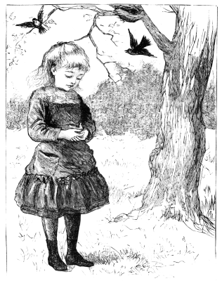 Girl holding baby robin next to the tree; parent birds flying around