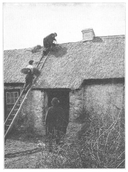 IRISH FARMER AND HIS SON PATCHING THE ROOF OF
THEIR OLD STONE HOUSE