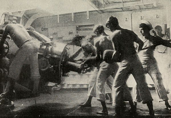 Men loading a large deck gun