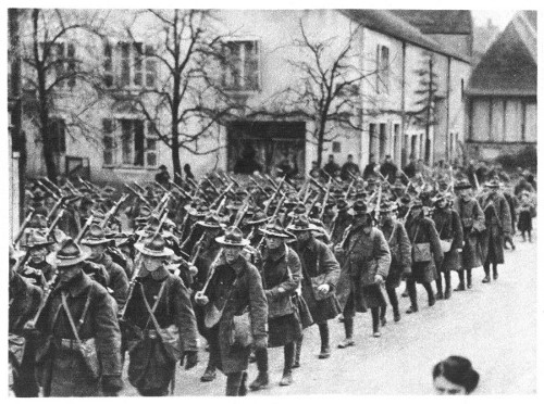 An American regiment marching through a French village