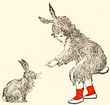 Child in bunny suit reaching down to pat a bunny