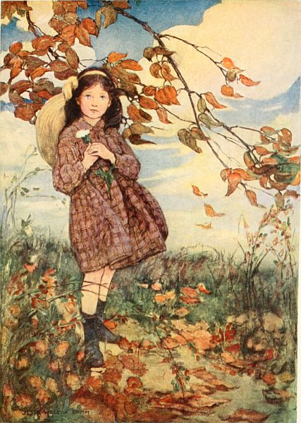 Girl standing in fall leaves