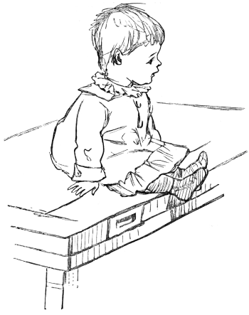 Little boy sitting on a table