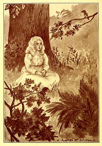 girl sitting with her back to a tree