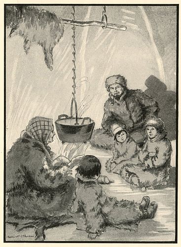 two boys listening to stories in tent by fire