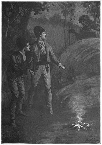Two boys standing by fire, someone approaching