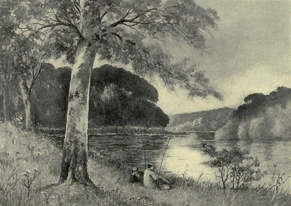 man on shore of water sitting on shore