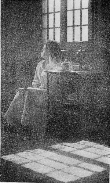 photograph of girl sitting by window