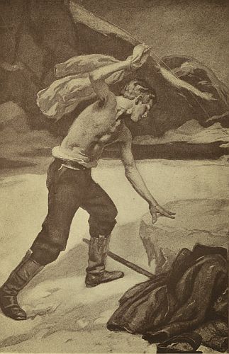 young man hitting clothes against rock