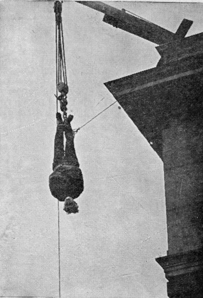 Houdini hanging upside down off building
