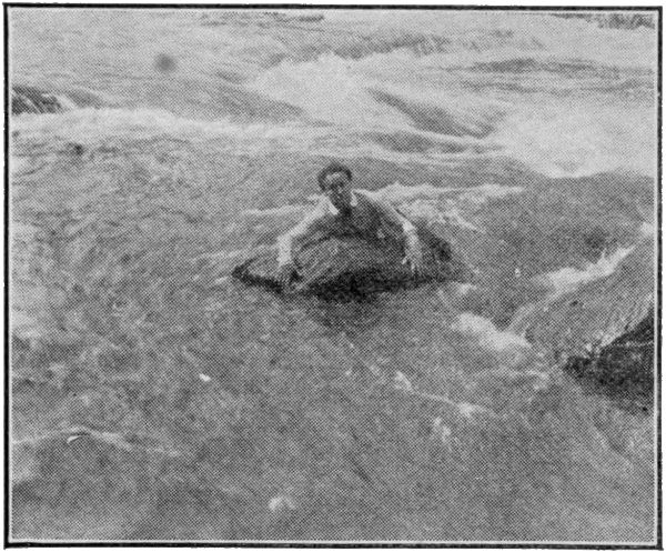 Houdini hanging onto rock in surging water