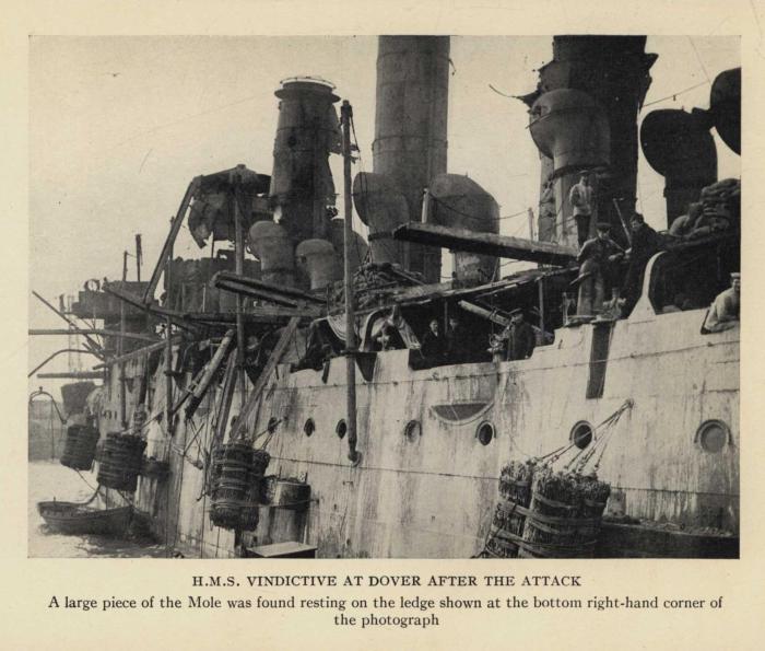 H.M.S. VINDICTIVE AT DOVER AFTER THE ATTACK. A large piece of the Mole was found resting on the ledge shown at the bottom right-hand corner of the photograph