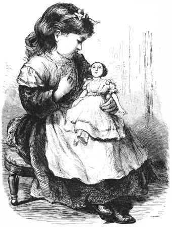 Little girl holding doll on lap talking to her