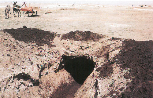 Underground channels carry water from nearby mountains into the Turpan Depression of China. If the channels were not covered, the water would evaporate quickly when it reached the hot, dry desert land.