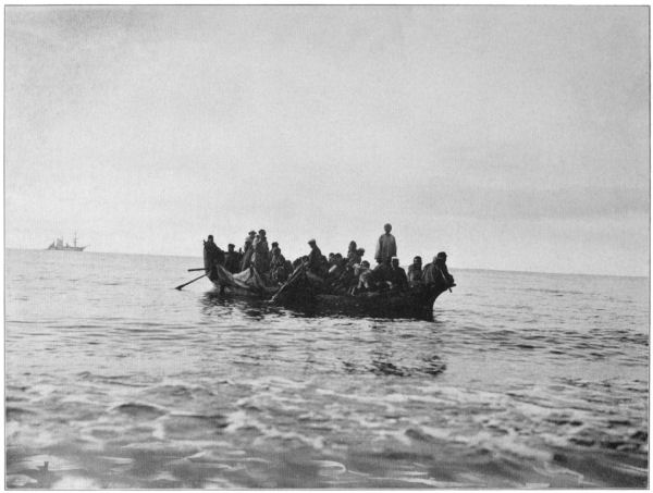 A group of people in a large canoe