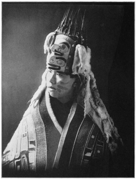 A young man wears a crested hat