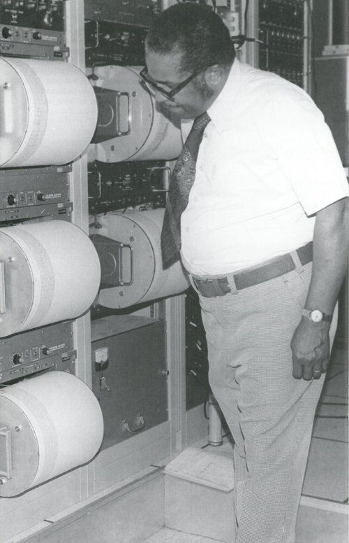 Scientist examining seismographic equipment.