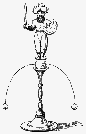 Toy man mounted on a candlestick with weights jutting out and down from both sides.