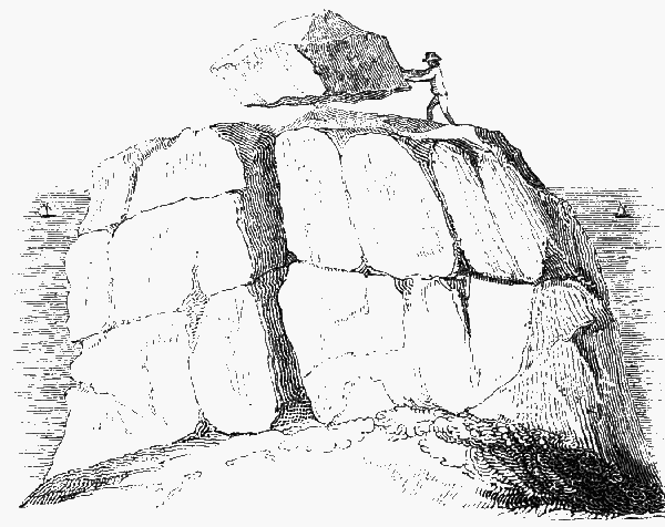Mound of stone with a boulder balanced atop a point in the middle.