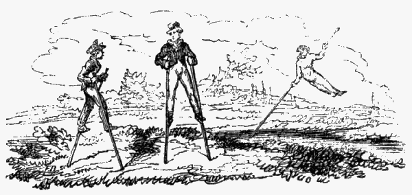 Three boys using stilts.