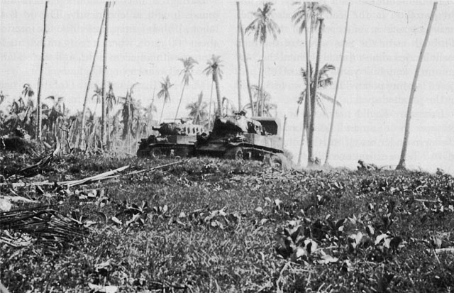 75-MM. M8 SELF-PROPELLED HOWITZERS move in to support the infantrymen in their advance from the beach.