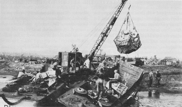 UNLOADING SUPPLIES AT DULAG on A Day (above), and (below) general view of the beach area on 22 October 1944.