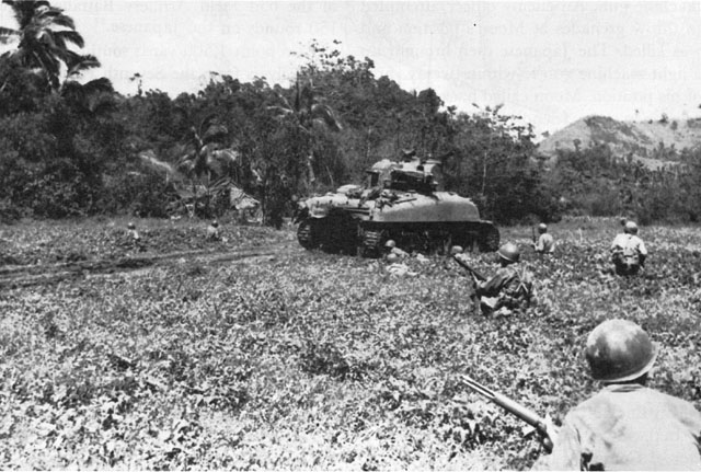 TANK-SUPPORTED INFANTRYMEN OF THE 34TH REGIMENT attack a hill near Pawing.