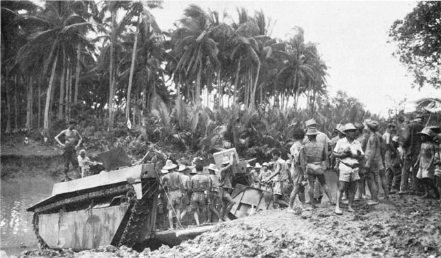 ROAD CONDITIONS. Disintegration of the roads greatly increased the supply problem. Filipino carriers unload an amphibious LVT(4) (above); carriers for the 1st Cavalry Division near Carigara (below).