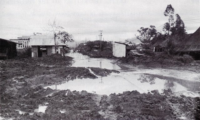 APPROACH ROAD TO QUARTERMASTER SERVICE CENTER at Tacloban after a heavy rain (above). The 7th Cavalry motor pool on 17 December 1944 (below).
