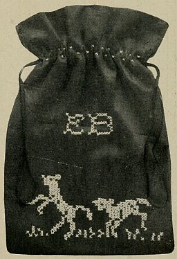 photo of dark coloured bag with gambolling lambs and a monogram