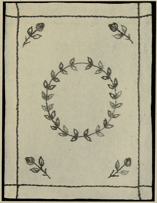 photo of rectangle with circle of leaves in center and roses in corners