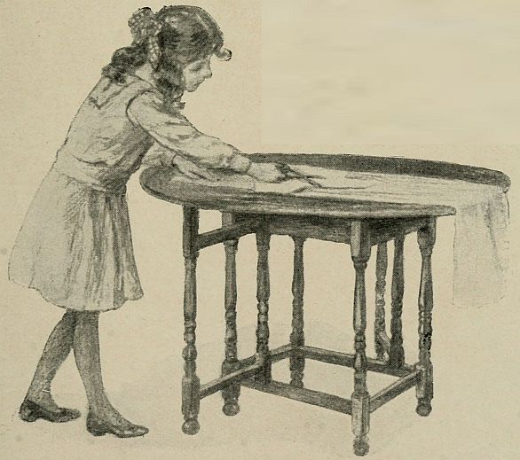 girl cutting out pattern on table