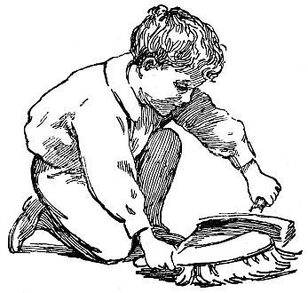 boy sweeping up with whisk broom and dustpan