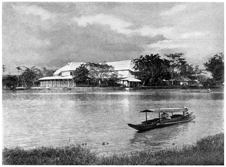 The English Club on the Banks of the Pasig. A Banca in the Foreground.
