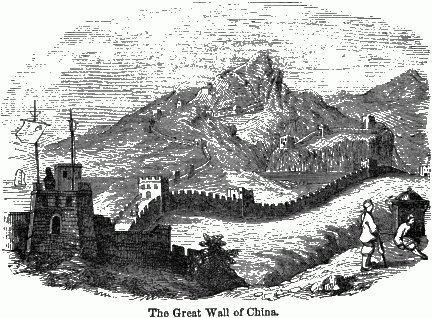 A long shot of part of the Great Wall with some men in the foreground.