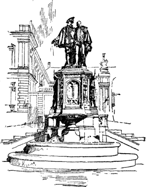Statue of two men on a pedestal in a city setting