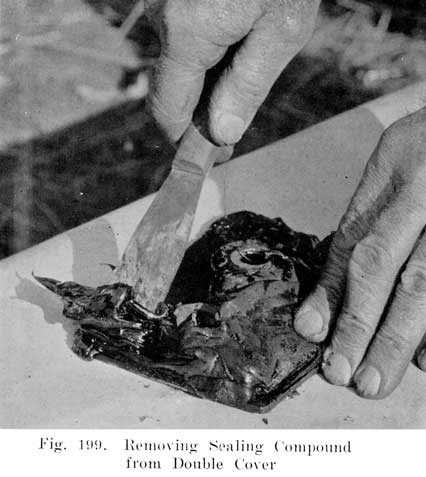 Fig. 199 Removing sealing compound from double cover