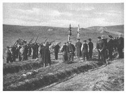 County volunteers of Islay firing a volley at the funeral of Tuscania victims at Kilnaughton, to the accompaniment of bagpipe lament (Times Photo Service)