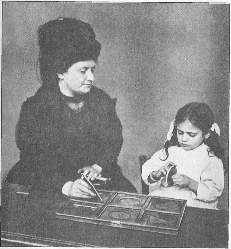 DR. MONTESSORI GIVING A LESSON IN TOUCHING GEOMETRICAL INSETS