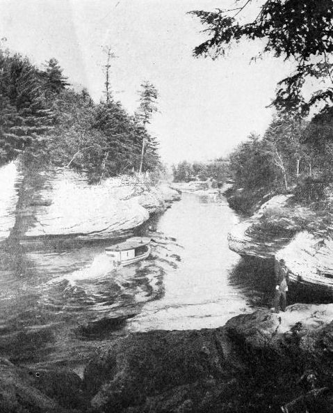 THE NARROWS, DELLS OF THE WISCONSIN  One hundred feet deep. The river seems almost to be running on its edge hemmed in by ponderous rocks. Courtesy Wisconsin Geological Survey
