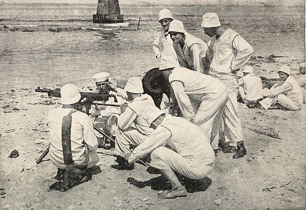 group of men crouched around a machine-type gun