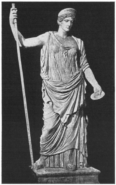 Hera stands leaning on a staff