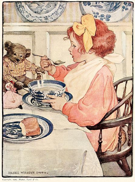 girl eating at table with napkin tied around her neck for a bib