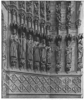 DETAILS OF CENTRAL PORCH (left-hand side)  The Apostles are represented in the following order (from left to right):  St. Peter, with cross and keys.  St. Andrew, with cross.  St. James, with sword (recalling his martyrdom), and wallet.  St. John, with beardless face, holds a cup, out of which comes a serpent.  The last two, with palm branch and axe, have not been identified.  The two prophets on the right are Isaiah (scroll) and Jeremiah (cross).  CENTRAL PORCH (left-hand side).  
