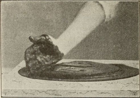 hand sideways in chocolate to scoop some up