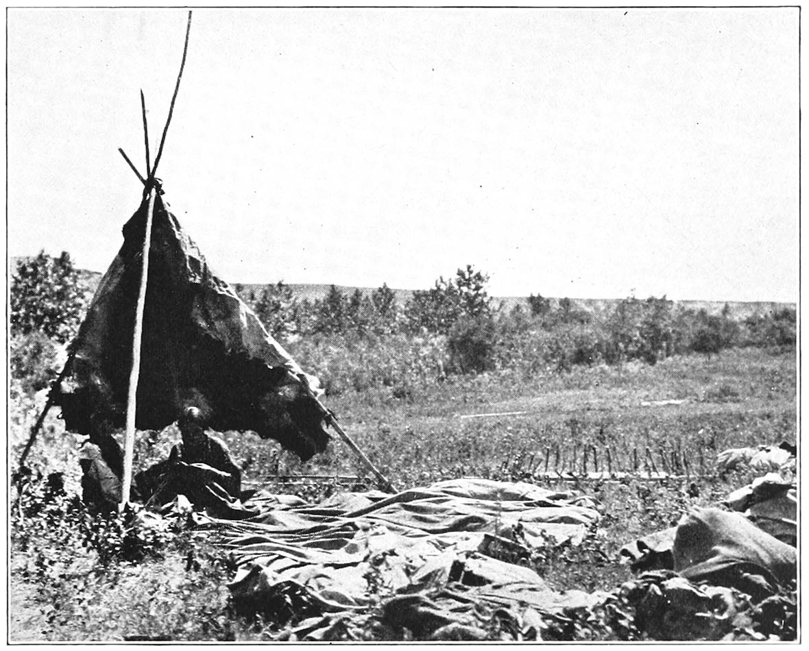 WOMAN REPAIRING A TEPEE-COVER