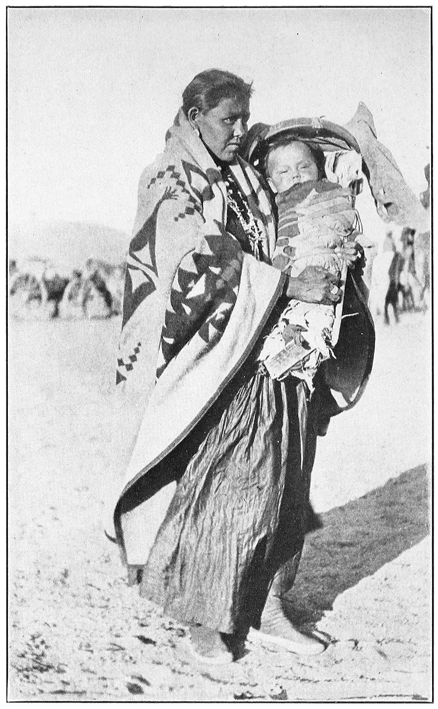 NAVAJO MOTHER, WITH A CHILD IN ITS CRADLE